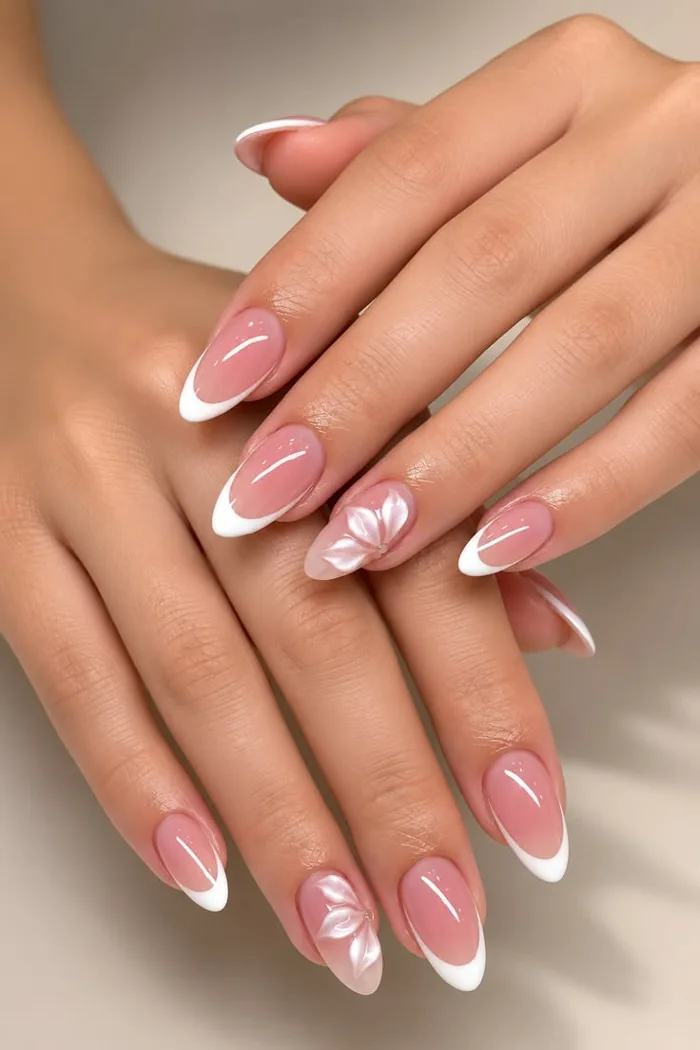 Almond nails with thin white French tips on a nude base. Almond nails with thin white French tips on a nude base.