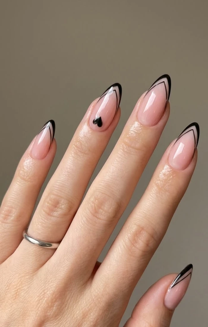 Almond-shaped French tip nails with a sheer nude base and white tips. Almond-shaped French tip nails with a sheer nude base and white tips.