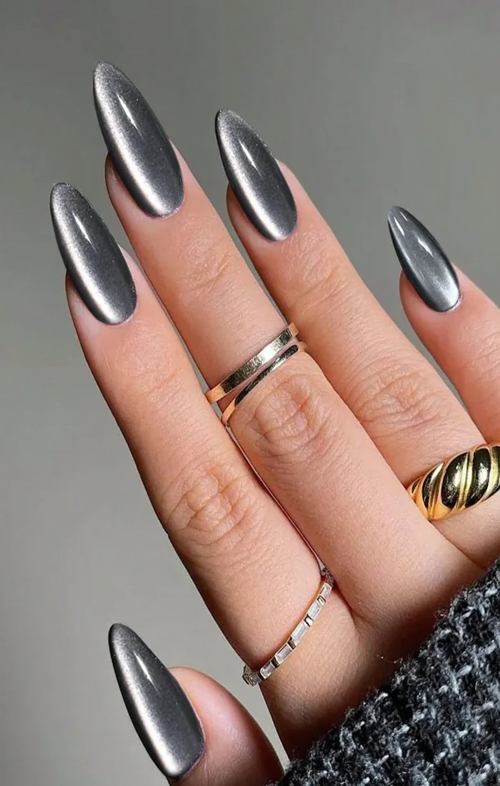 Black cat eye nails with reflective silver chrome accents. Black cat eye nails with reflective silver chrome accents.