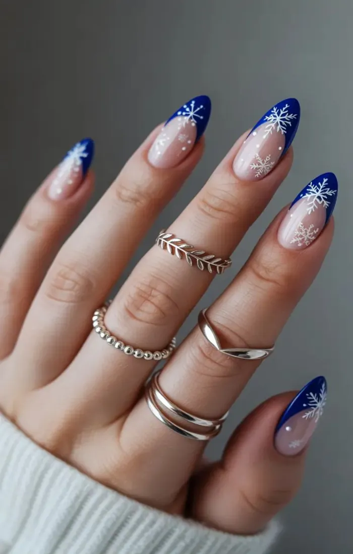 Blue and silver winter Christmas nails with snowflake details Blue and silver winter Christmas nails with snowflake details