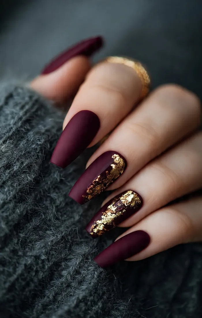 Burgundy Christmas nails with delicate gold foil accents Burgundy Christmas nails with delicate gold foil accents