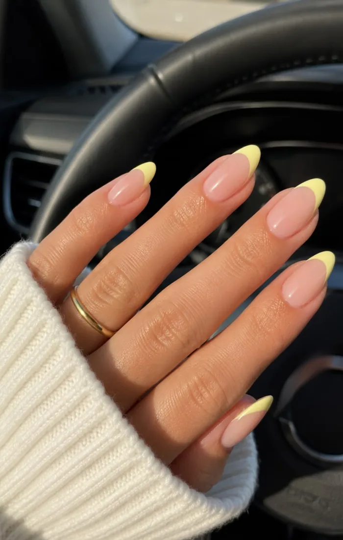 Butter yellow French tip nails with a sheer pink base. Butter yellow French tip nails with a sheer pink base.