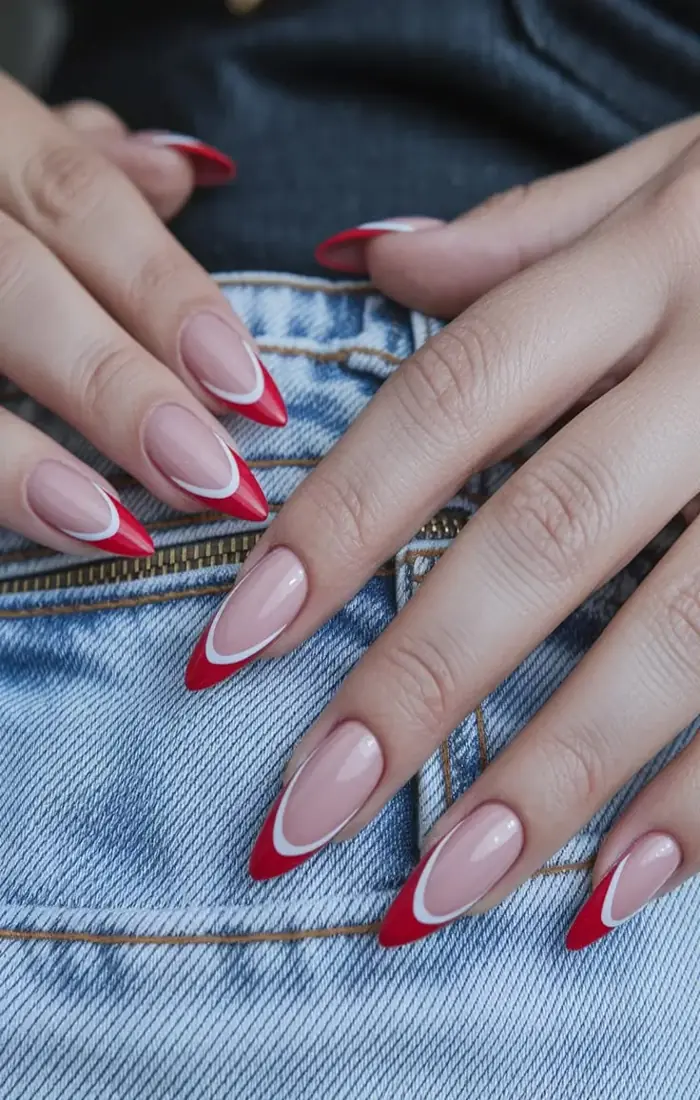 Cherry red French tip nails with a sheer nude base Cherry red French tip nails with a sheer nude base