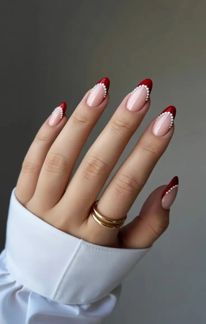 Christmas French tip nails with red and green edges and festive details. Christmas French tip nails with red and green edges and festive details.
