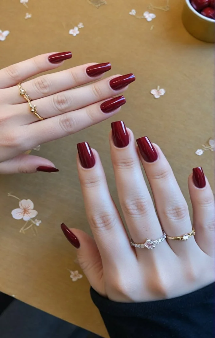 Classic glossy red coffin nails with a smooth, vibrant finish Classic glossy red coffin nails with a smooth, vibrant finish