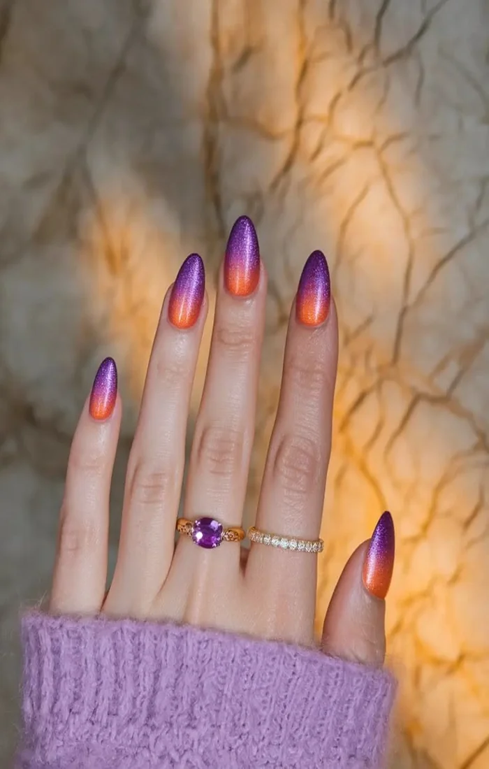 End-of-summer sunset nails blending peach, coral, pink, and purple shades. End-of-summer sunset nails blending peach, coral, pink, and purple shades.