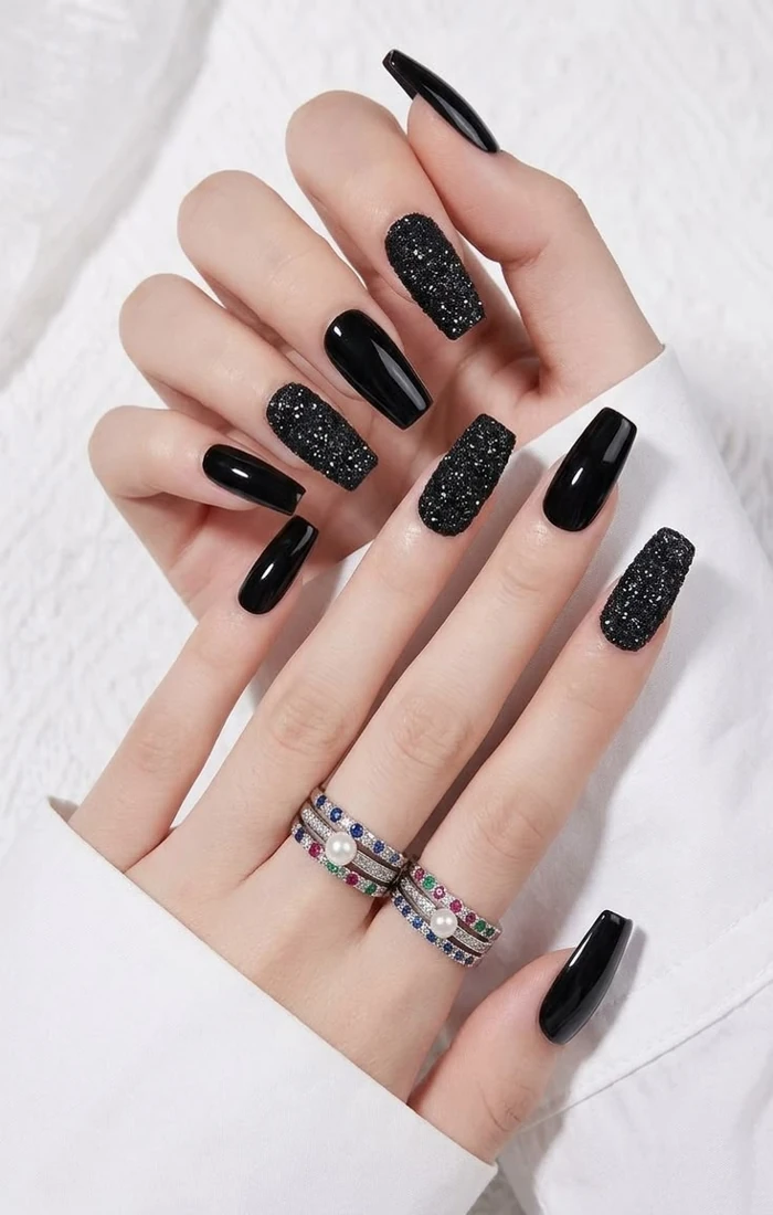 Glossy black coffin nails with a bold solid-color finish Glossy black coffin nails with a bold solid-color finish