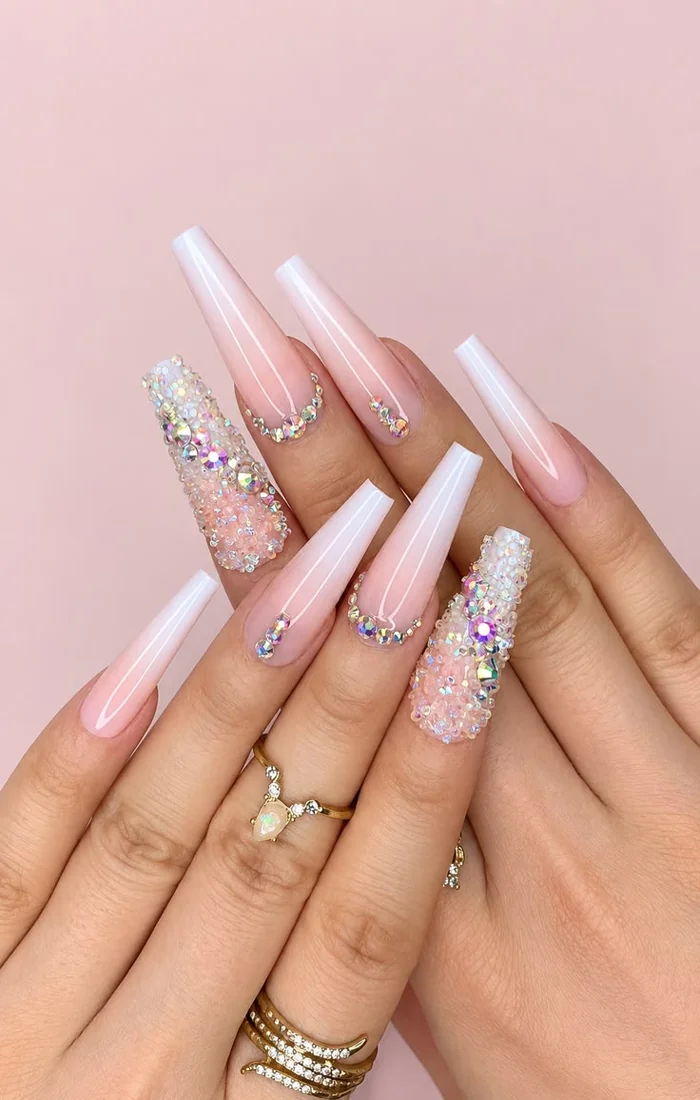 Long coffin nails with glossy polish and sparkling rhinestone accents Long coffin nails with glossy polish and sparkling rhinestone accents