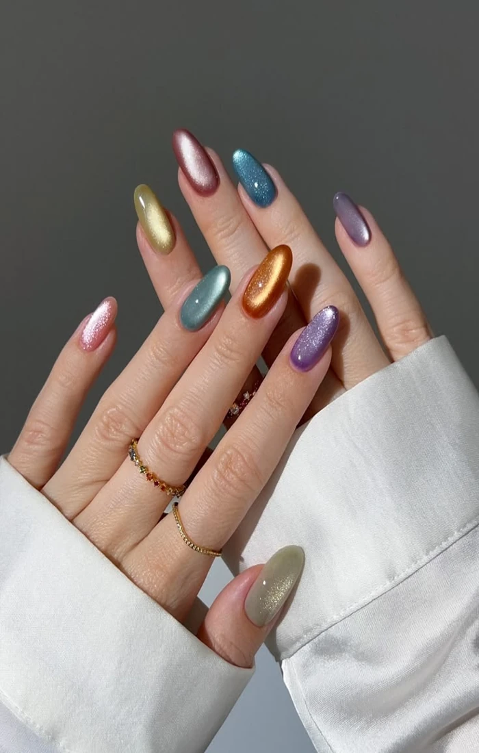 Multicolor cat eye nails in pink, blue, green, and taupe. Multicolor cat eye nails in pink, blue, green, and taupe.