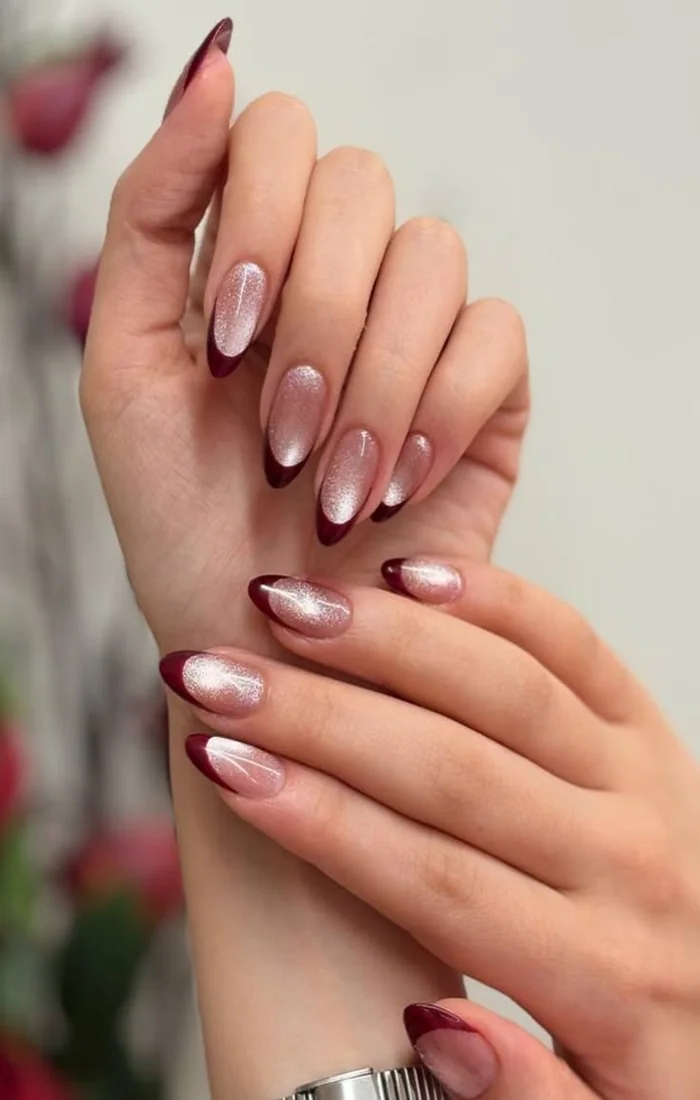 Nude almond nails with shimmering silver cat eye French tips. Nude almond nails with shimmering silver cat eye French tips.