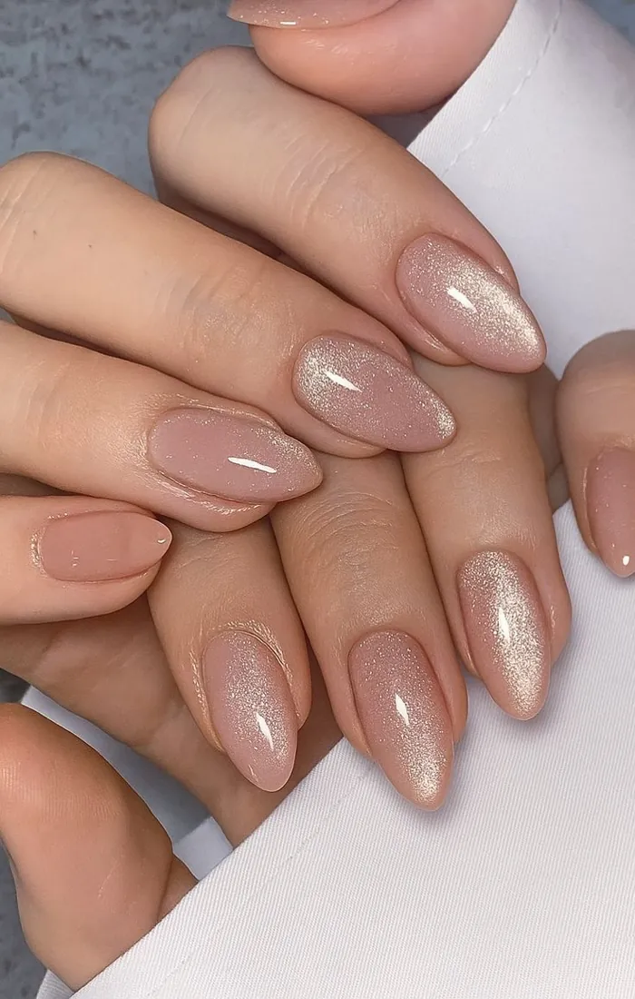 Nude cat eye nails with soft golden magnetic highlights. Nude cat eye nails with soft golden magnetic highlights.