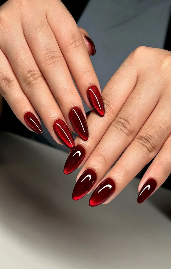 Ruby red cat eye nails with reflective magnetic highlights. Ruby red cat eye nails with reflective magnetic highlights.