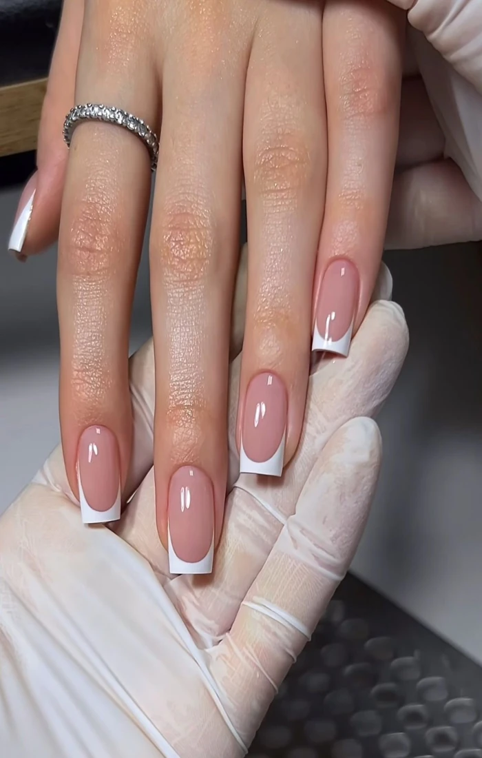 Short French tip nails with delicate white edges on natural-looking nails Short French tip nails with delicate white edges on natural-looking nails