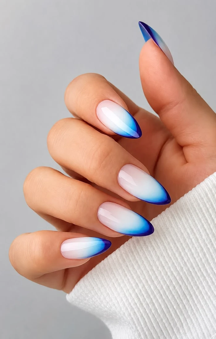 Simple blue French tip summer nails on a sheer nude base. Simple blue French tip summer nails on a sheer nude base.