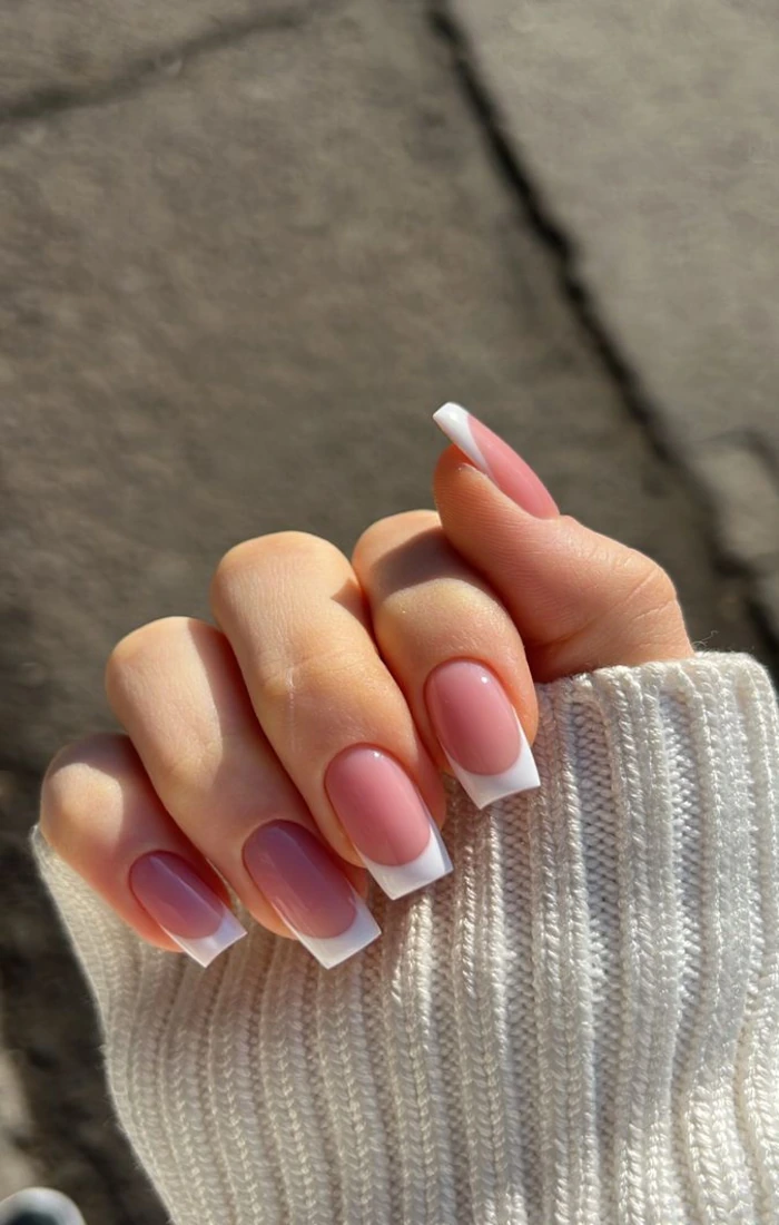 Square French tip nails with crisp white tips and a pink base. Square French tip nails with crisp white tips and a pink base.
