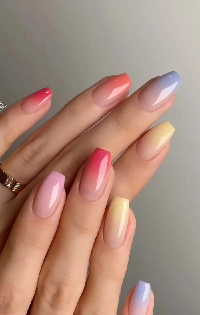 Summer ombre nails blending pink and orange into a soft sunset gradient. Summer ombre nails blending pink and orange into a soft sunset gradient.