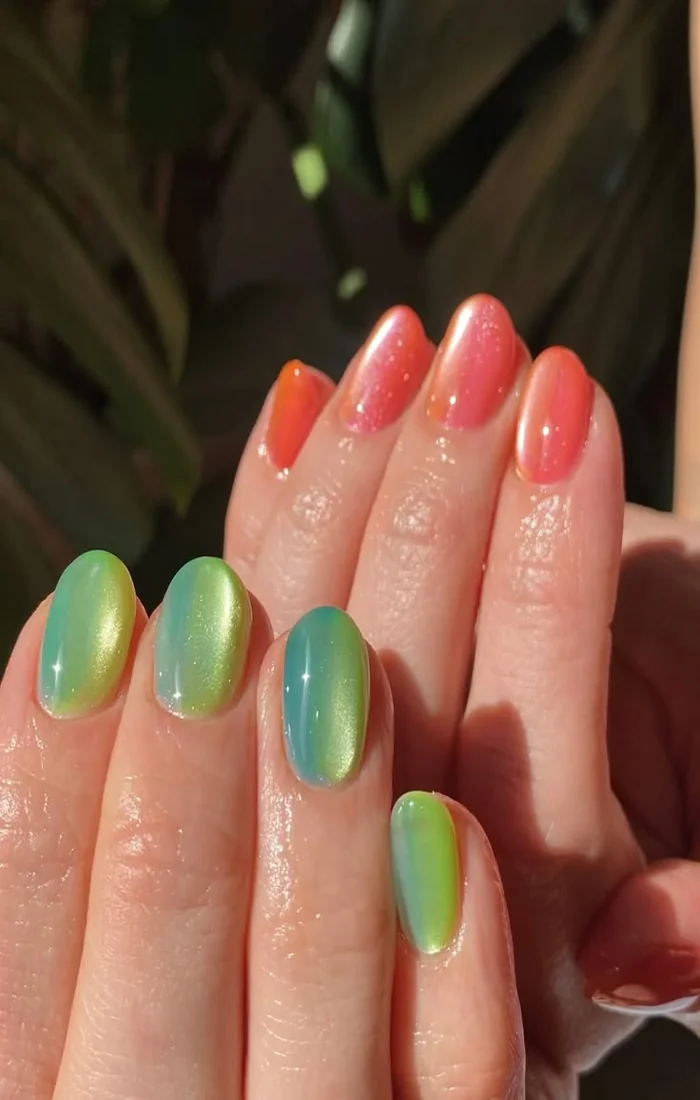 Turquoise and coral summer cat eye nails with luminous shimmer. Turquoise and coral summer cat eye nails with luminous shimmer.