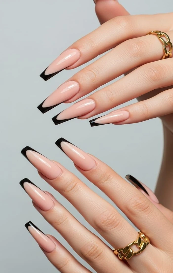 V French tip coffin nails with sharp white angles over a nude base V French tip coffin nails with sharp white angles over a nude base